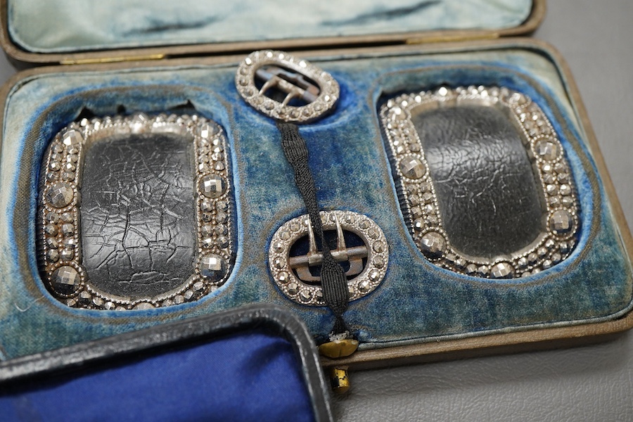 A collection of cased buckles, 19th century, two sets in cut steel, one set in gilt metal, each in a fitted case